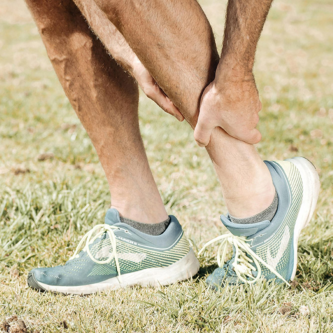 hand touching ankle