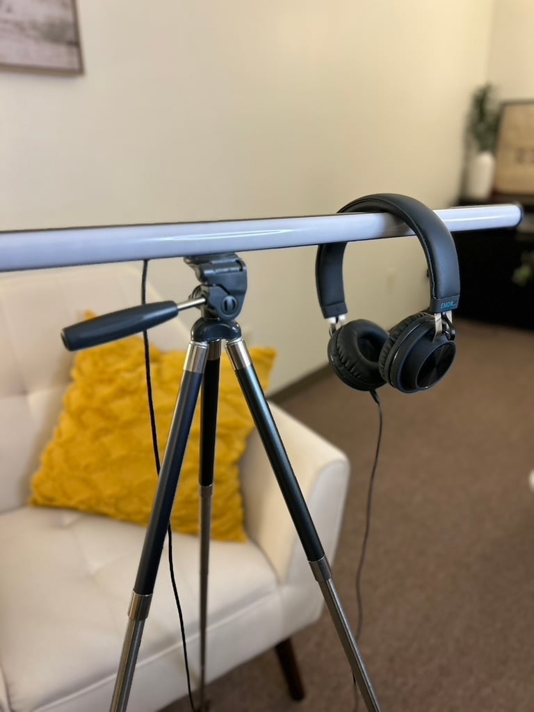 EMDR therapy equipment used by a mental health therapist, including headphones and a light bar in a calming office setting at Redbird Wellness.
