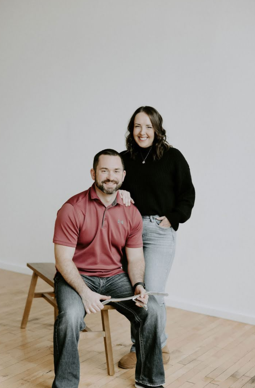 Redbird Wellness team Shawn Halliday, chiropractor, and Brooke Halliday, therapist, smiling together in studio portrait.