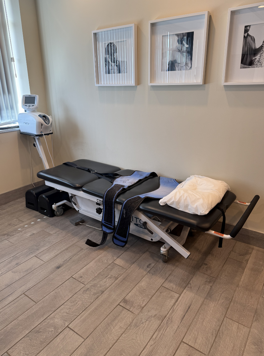 Spinal decompression treatment table setup in a calm, modern chiropractic therapy room.