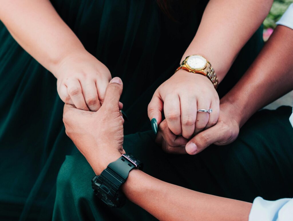 Couple holding hands closely, symbolizing trust, emotional connection, and healthy relationships.