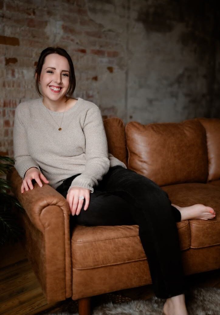 Licensed therapist sitting in a welcoming office environment providing counseling and EMDR therapy for trauma and emotional healing.